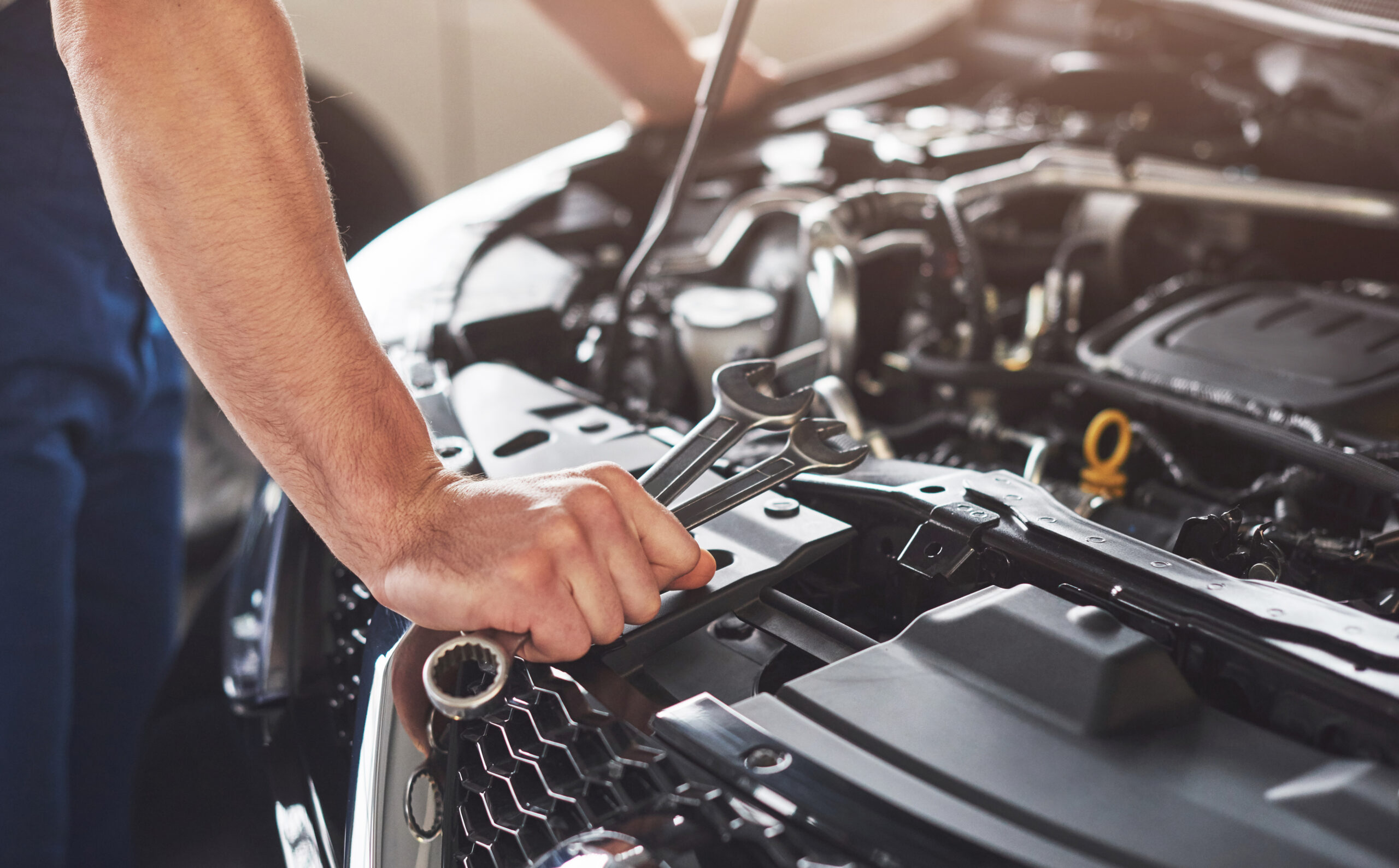 Automotive Transportation 27 muscular car service worker repairing vehicle scaled