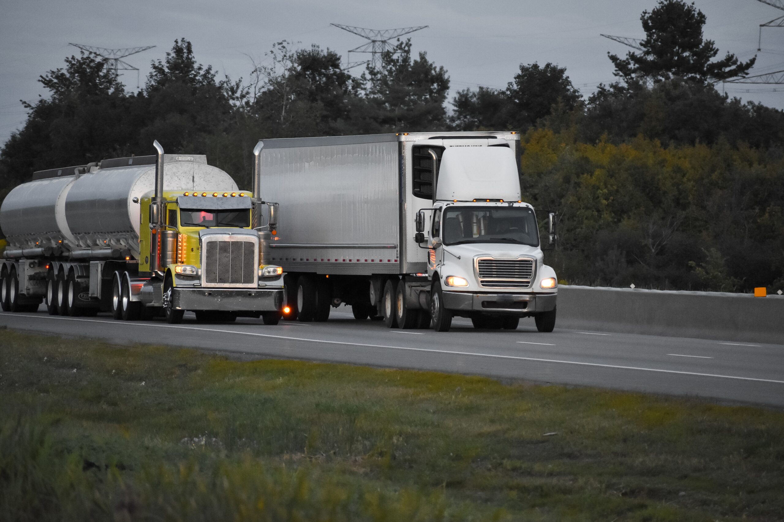 Automotive Transportation 29 trailer trucks driving road surrounded by beautiful green trees scaled