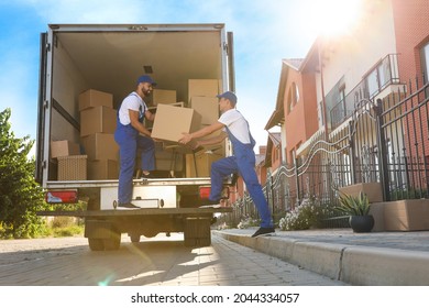 workers unloading boxes van outdoors 260nw 2044334057